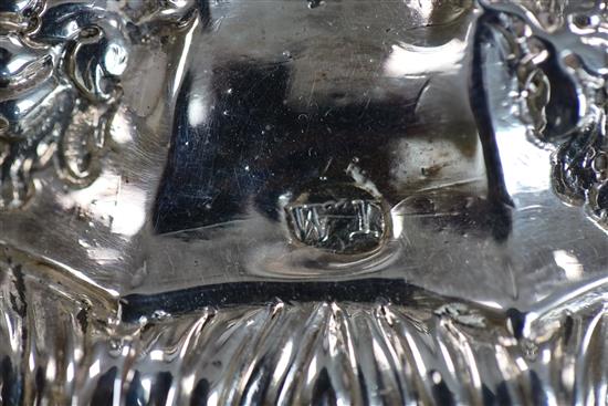 A pair of late George II embossed silver candlesticks, by William Tuite, weighted.